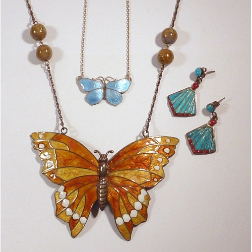 64 - A butterfly motif necklace, enamelled white metal marked STG SIL, 83mm across wings; a smaller butte... 