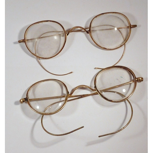 68 - Two pairs of early 20th cent spectacles, one marked 9ct at the bridge, one marked 10ct at the bridge... 