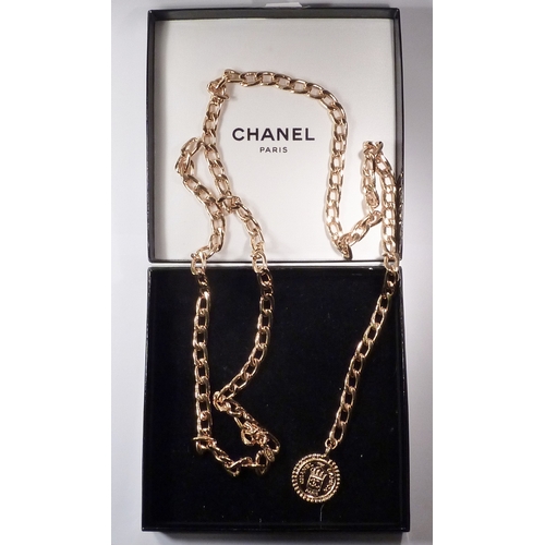 105 - A Chanel rue Cambon chain link belt having a medallion terminal. Gilt base metal signed Chanel / Mad... 