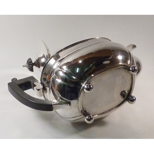 13 - A silver teapot having composite knop and handle.  270mm long / 590g