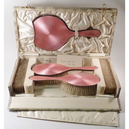 21 - A silver and pink enamel part brush set, cased.  A/F comb lacking.