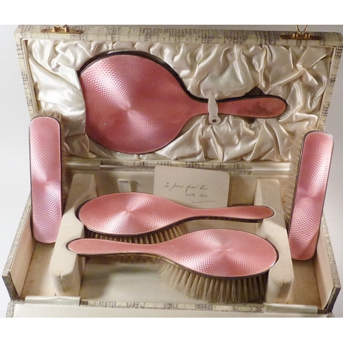 21 - A silver and pink enamel part brush set, cased.  A/F comb lacking.