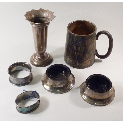 22 - Silver: a christening mug, a vase, a pair of salts, two napkin rings.  240g weighable.