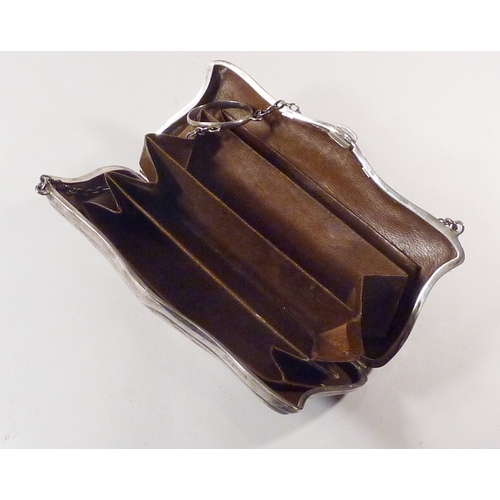 23 - An early 20th cent ladies'  silver purse with leather lining, 125 x 60mm suspended on a finger loop ... 