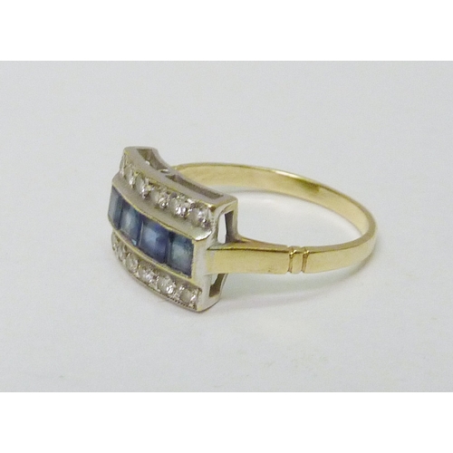 74 - A three row cluster ring being four calibre cut sapphires flanked by two rows each comprising six br... 