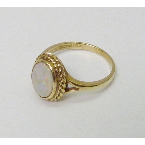 75 - A 9ct gold opal ring.  Opal 10 x 7mm oval / 4g gross