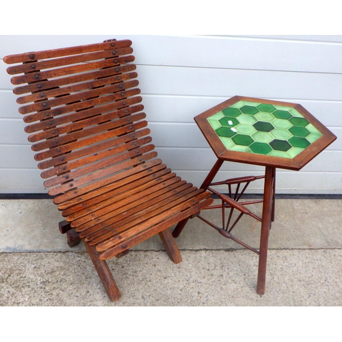 790 - A slatted chair together with a tile topped hexagonal occasional table, (a/f) (2)