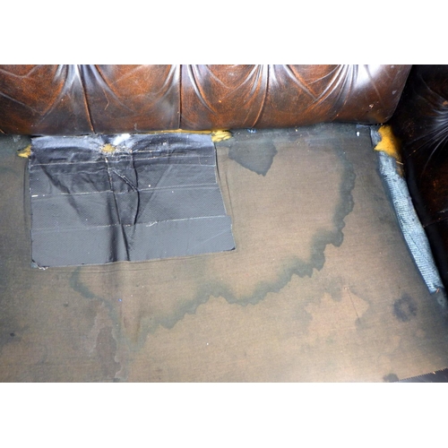 792 - A button back leather settee, later cushions, split arm, damage, 180cm wide