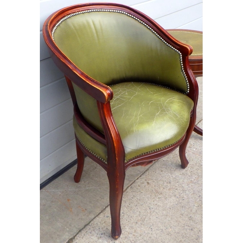 798 - A green leather upholstered tub chair together with a drum topped occasional table (2)