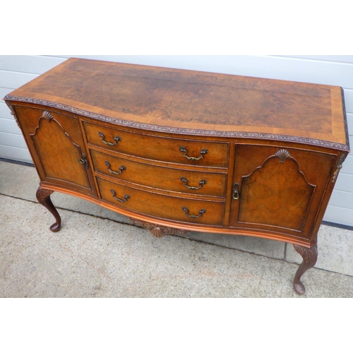 814 - A walnut sideboard with crossbanded top on cabriole legs, 150cm wide