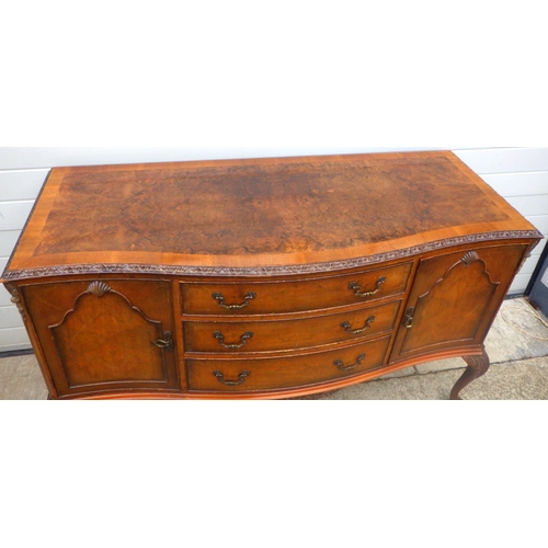 814 - A walnut sideboard with crossbanded top on cabriole legs, 150cm wide