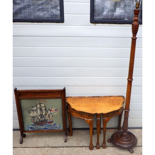 815 - A walnut nest of occasional tables, needlework firescreen and a mahogany lamp standard (3)