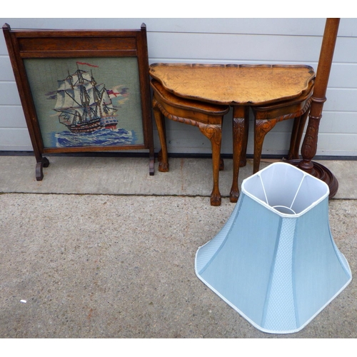 815 - A walnut nest of occasional tables, needlework firescreen and a mahogany lamp standard (3)