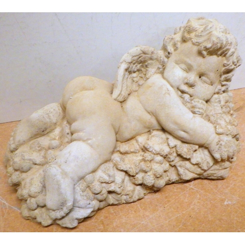 830 - A concrete garden figure of a sleeping cherub, 27cm long