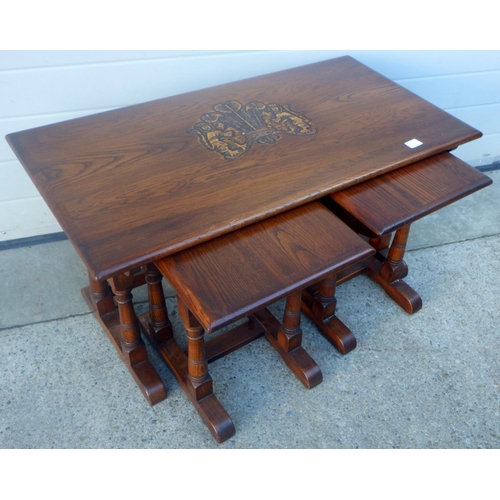 834 - An Old Charm oak coffee table with two under tables, carved top 