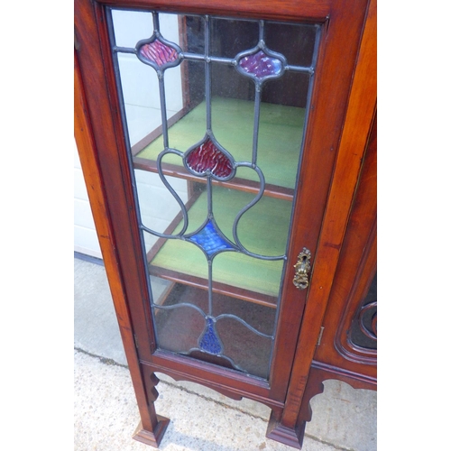 849 - An Edwardian, Art Nouveau inlaid side cabinet with leaded glass doors, top arched rail fractured, 14... 