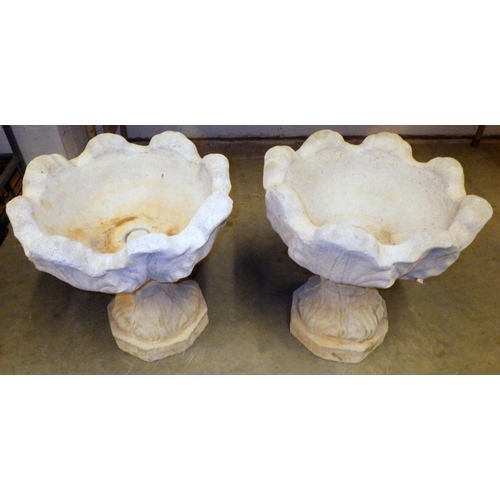 865 - A pair of tulip shaped concrete garden urns, 46cm across