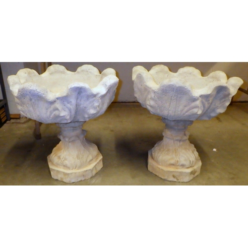 865 - A pair of tulip shaped concrete garden urns, 46cm across