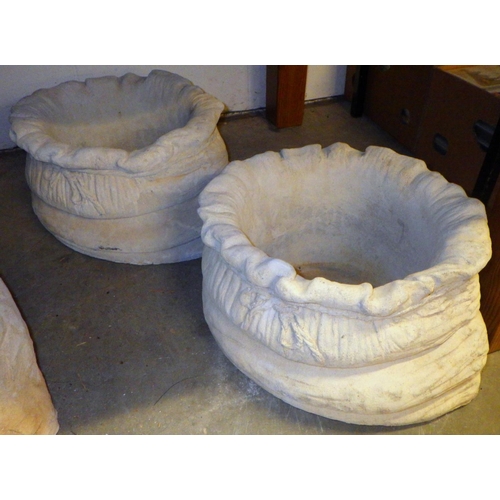 877 - A pair of sack shaped concrete garden planters 41cm across