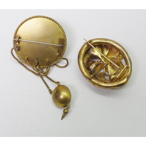 115 - A historic revival brooch, c1900, 42mm diameter; another brooch of similar period; a photograph lock... 