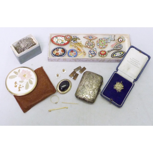 121 - A silver cigarette case, a silver napkin ring, various brooches etc.