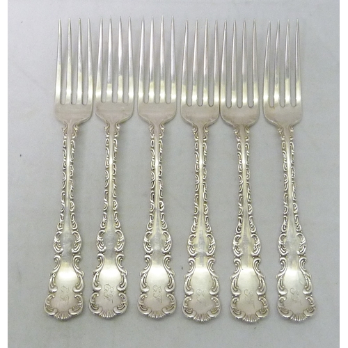 123 - Six matching white metal dessert forks having profusely scrolled border design, Toronto Silver Plate... 