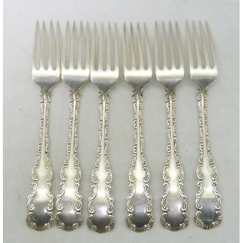 123 - Six matching white metal dessert forks having profusely scrolled border design, Toronto Silver Plate... 