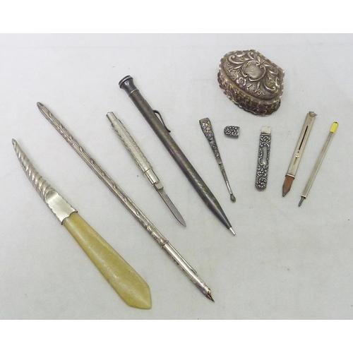 136 - A silver pencil holder, 49mm long; a bridge scorer pencil(?) white metal marked sterling; a silver p... 