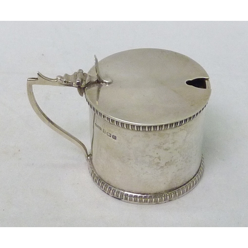 137 - A silver mustard pot; six various silver or silver handled knives; a silver sugar tongs and a white ... 