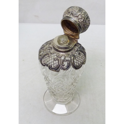 140 - A cut glass scent with a silver collar and hinged lid, complete with inner stopper, 165mm tall; a cu... 