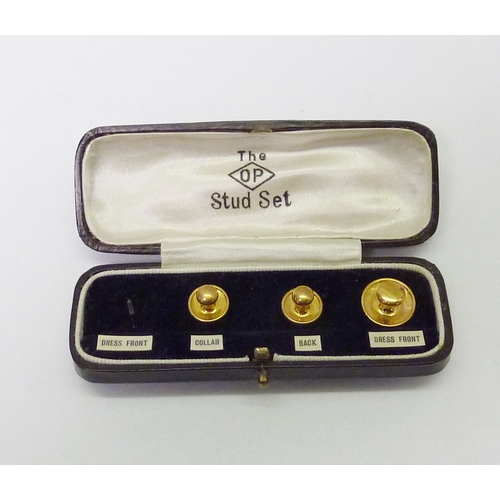 143 - A part set of three dress studs, yellow metal marked 9ct.