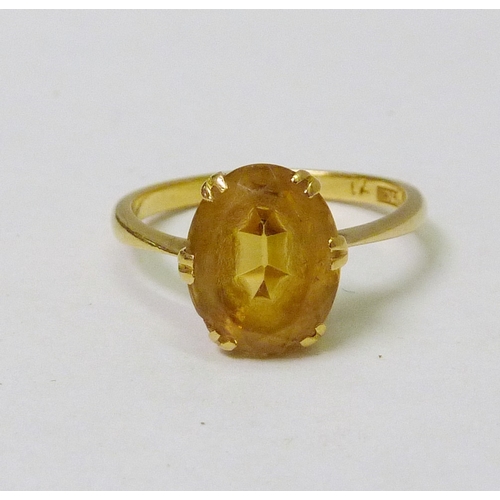 145 - A cocktail ring set with a citrine, yellow metal marked 22ct.  12 x 8mm.