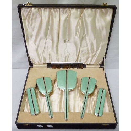 165 - A six piece silver and enamel brush set presented in an Ogdens of Harrogate presentation case, a/f.