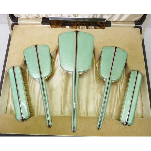 165 - A six piece silver and enamel brush set presented in an Ogdens of Harrogate presentation case, a/f.