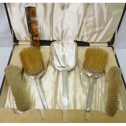 165 - A six piece silver and enamel brush set presented in an Ogdens of Harrogate presentation case, a/f.