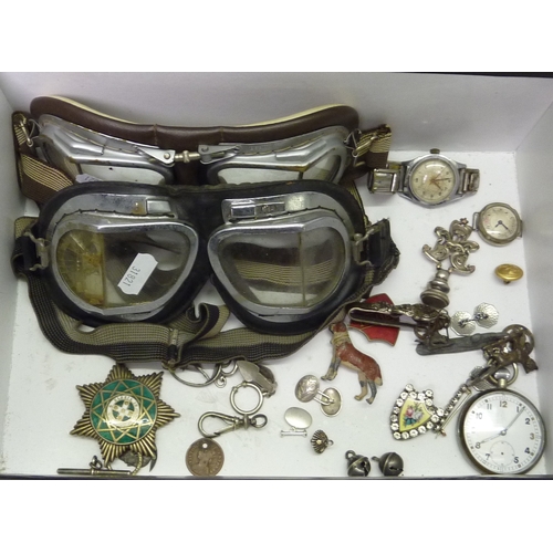 172 - A collectors' lots incl badges, cufflinks, watches, and two pairs of motorcycle goggles.