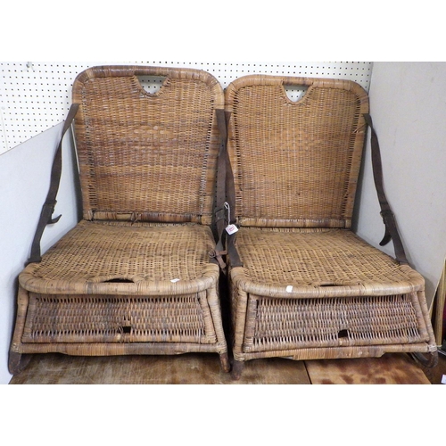 63 - A pair of vintage wicker fishing chairs, the folding backs held by leather straps, af