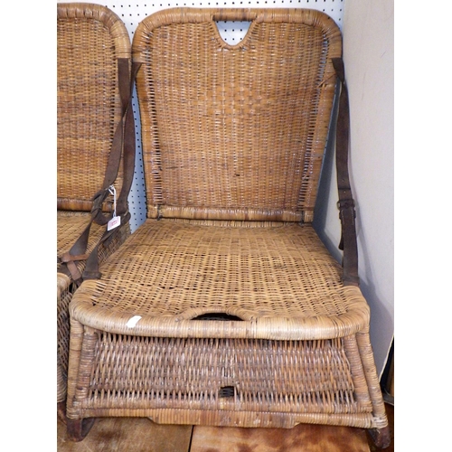 63 - A pair of vintage wicker fishing chairs, the folding backs held by leather straps, af