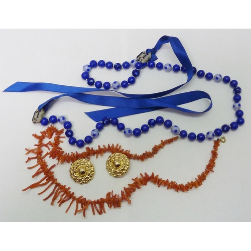 301 - A Chanel spotted glass bead necklace fastening on blue silk ribbons, beads and CC logos 700mm long, ... 