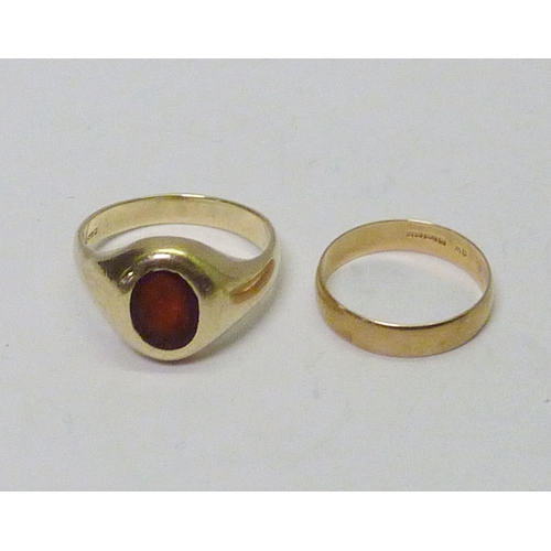 314 - A 9ct gold red stone set signet ring, a/f abraded and setting worn; a 9ct gold band ring. (2)  10g g... 