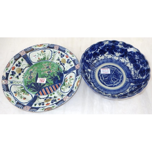 162 - An Oriental blue and white bowl 25cm diameter together with a restored charger (2)