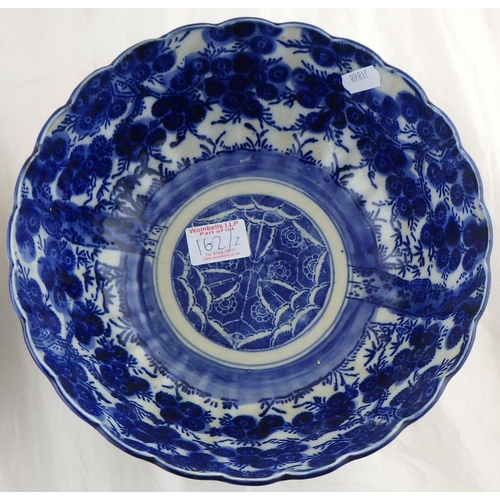 162 - An Oriental blue and white bowl 25cm diameter together with a restored charger (2)