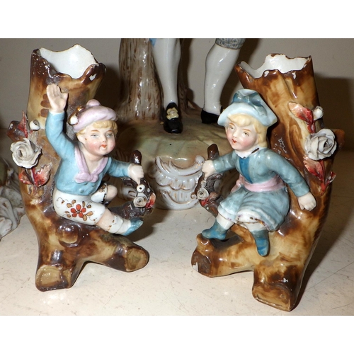 232 - Two continental porcelain candlesticks together with a small pair of spill vases AF