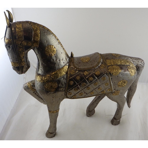 274 - An Oriental gilt and white metal horse 49cm tall