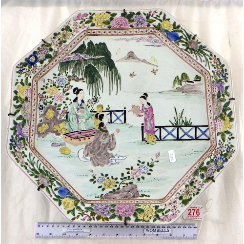 276 - A large Oriental octagonal plate decorated with scenes of ladies having tea 44cm wide af small resto... 