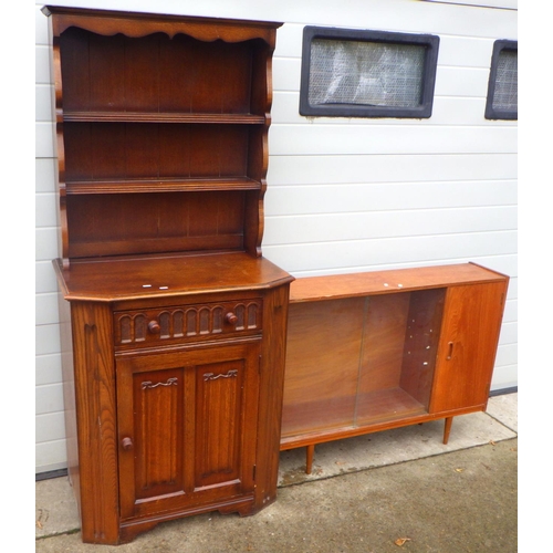 763 - A teak low cabinet with sliding glass doors together with a narrow linenfold oak/ply dresser, veneer... 