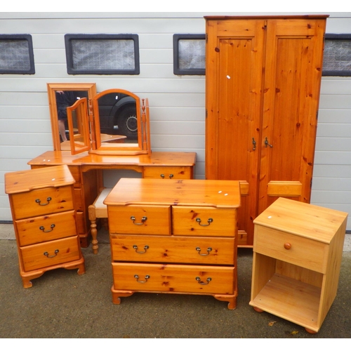 766 - A modern pine wardrobe, chest of drawers, dressing table, mirror & bedside chest together with anoth... 