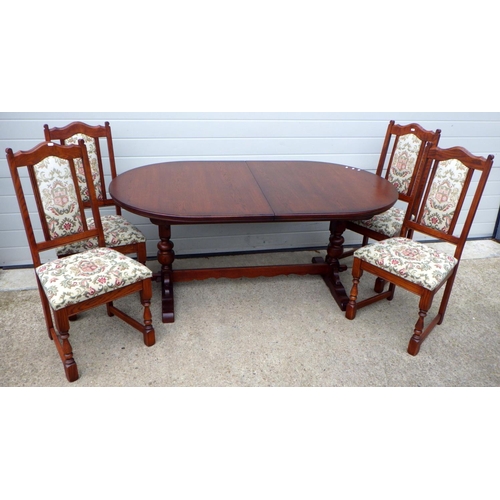 775 - An Old Charm dining table with extending centre leaf & four chairs