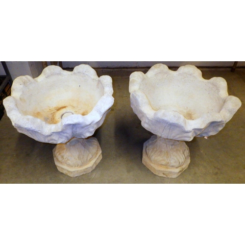 789 - A pair of tulip shaped concrete garden urns, 46cm across
