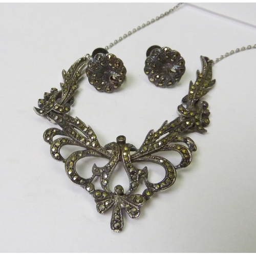 398 - A white metal and marcasite ladies watch; a white metal and marcasite necklace and earring set; a Sc... 